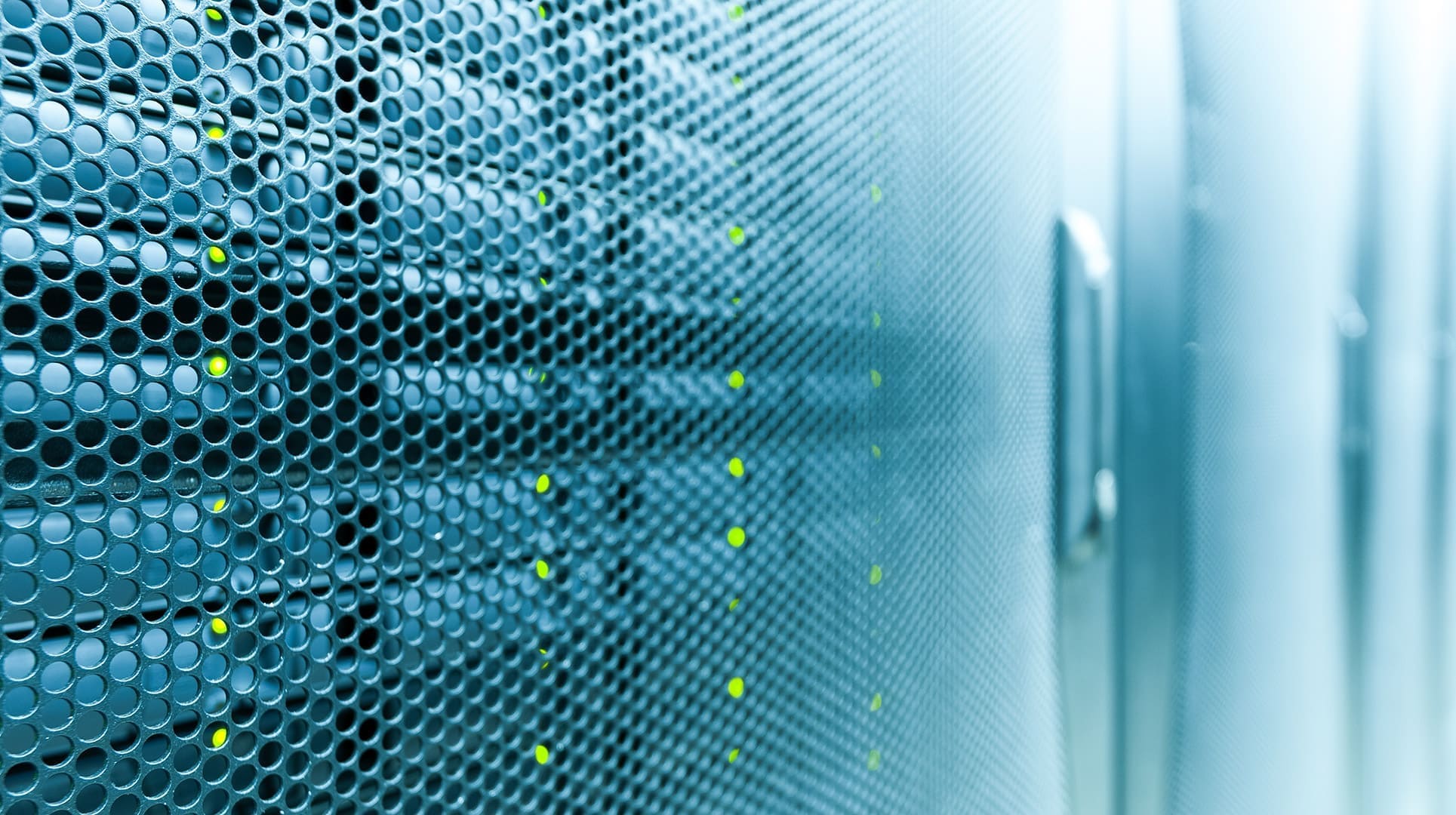 Close-up of perforated server cabinet doors with rows of green status lights